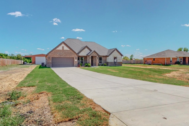 view of front of home featuring a front yard and a garage