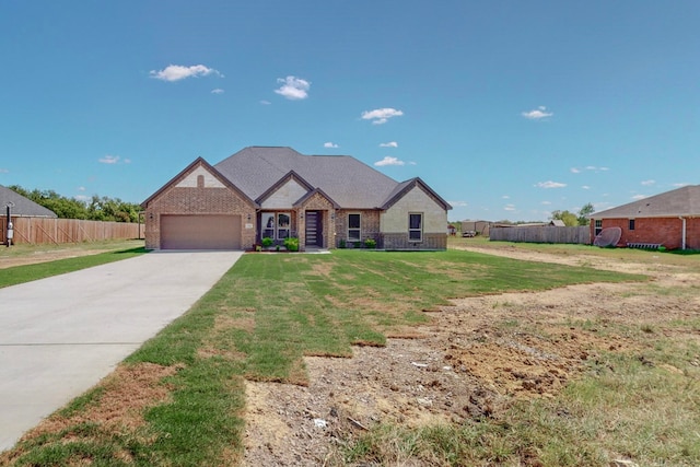 view of front of home featuring a garage and a front lawn