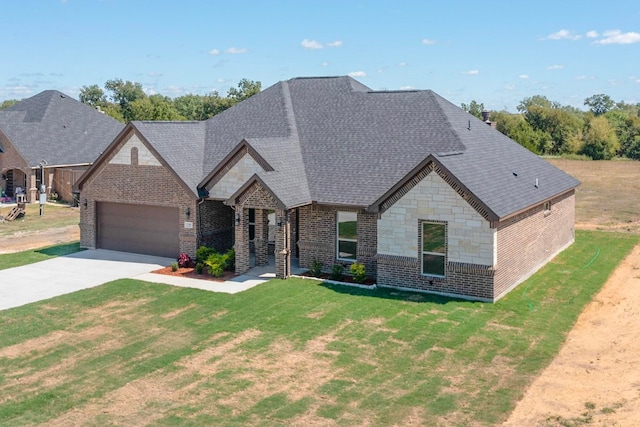 view of front of property featuring a front yard and a garage