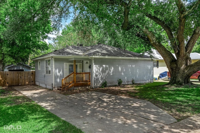 ranch-style house featuring a porch and a front lawn