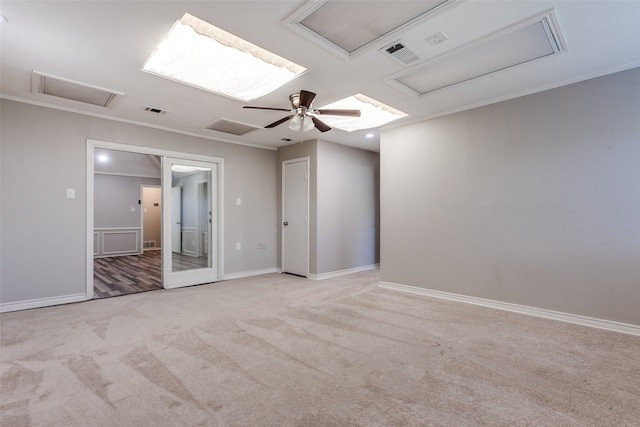 spare room with crown molding, light carpet, and ceiling fan