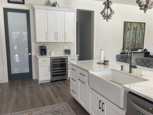 kitchen featuring white cabinetry, beverage cooler, light stone counters, dark hardwood / wood-style floors, and pendant lighting