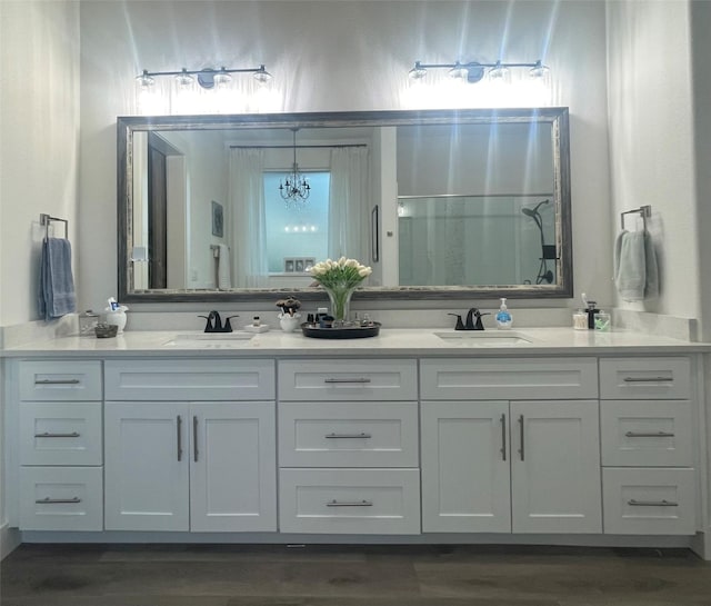 bathroom featuring hardwood / wood-style flooring, vanity, and an inviting chandelier