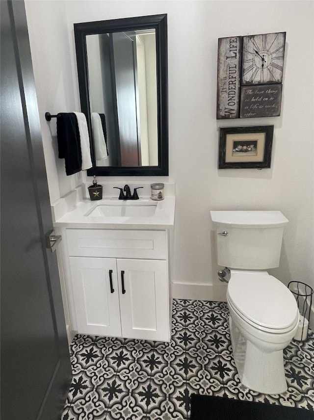 bathroom featuring tile patterned floors, vanity, and toilet