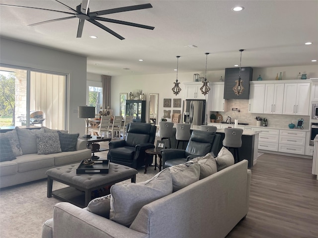 living room with hardwood / wood-style floors and ceiling fan