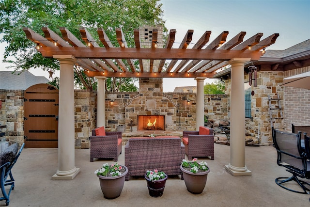 view of patio with an outdoor stone fireplace and a pergola