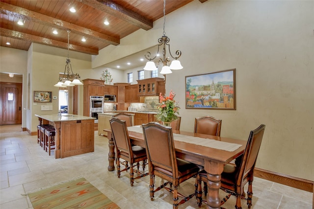 dining space featuring a healthy amount of sunlight, high vaulted ceiling, an inviting chandelier, and wooden ceiling