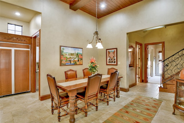 dining area featuring a chandelier, high vaulted ceiling, and wooden ceiling