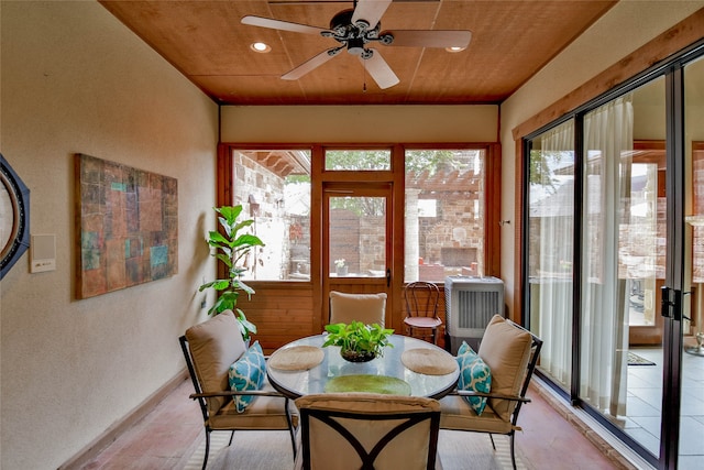 sunroom featuring ceiling fan, wooden ceiling, and a wealth of natural light