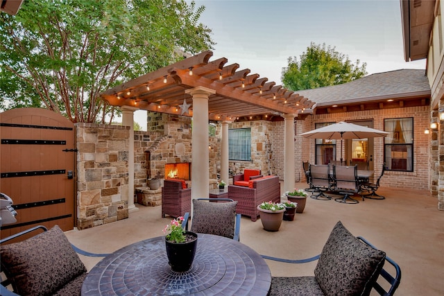 view of patio / terrace with an outdoor stone fireplace and a pergola