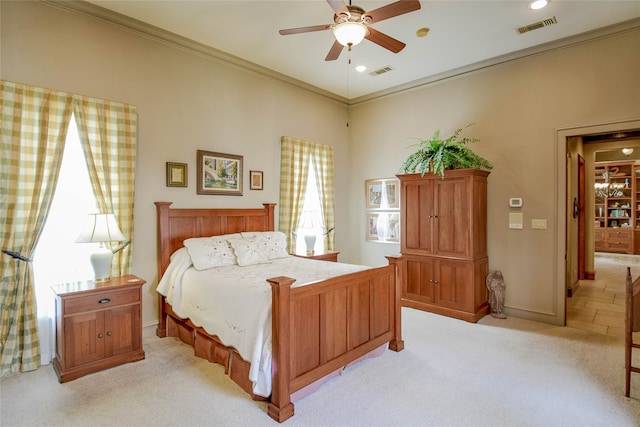 bedroom with ceiling fan, crown molding, and light carpet