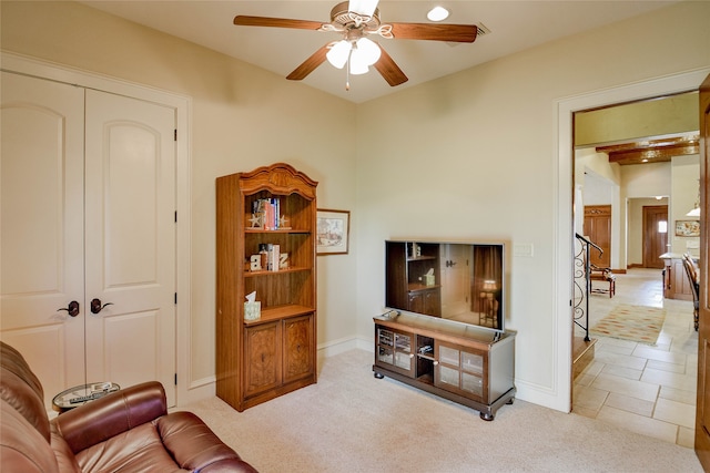 carpeted living room featuring ceiling fan