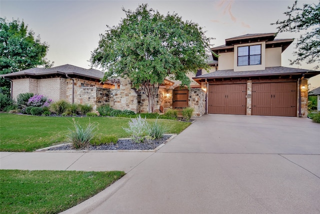 prairie-style house with a garage and a yard