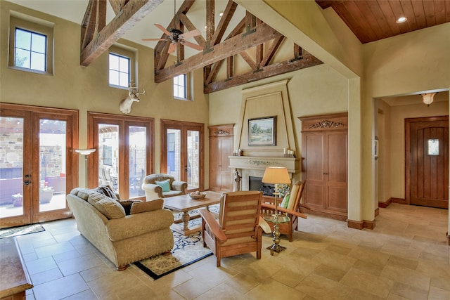 living room featuring high vaulted ceiling, french doors, ceiling fan, light tile patterned floors, and beamed ceiling