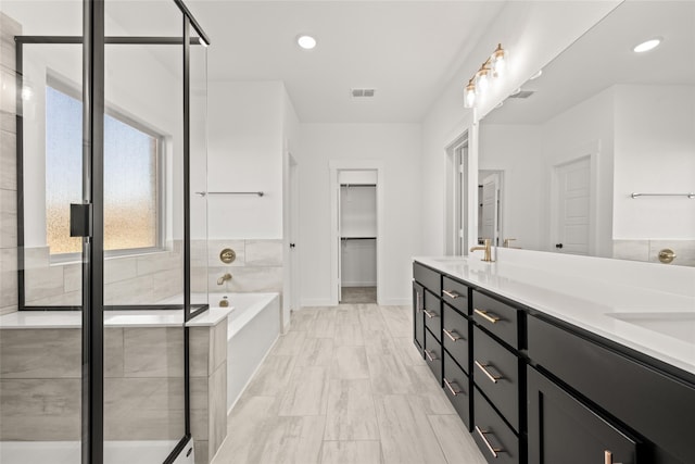 7513 Wild Mint Trl, Midlothian, TX 76084 - bathroom with a garden tub, double vanity, a stall shower, baseboards, and marble look tile flooring