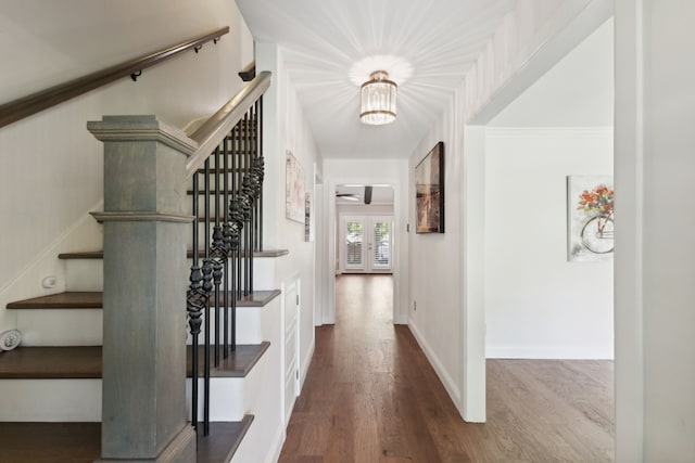 hallway with hardwood / wood-style flooring and french doors