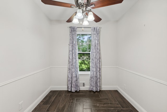 unfurnished room featuring dark hardwood / wood-style floors and ceiling fan