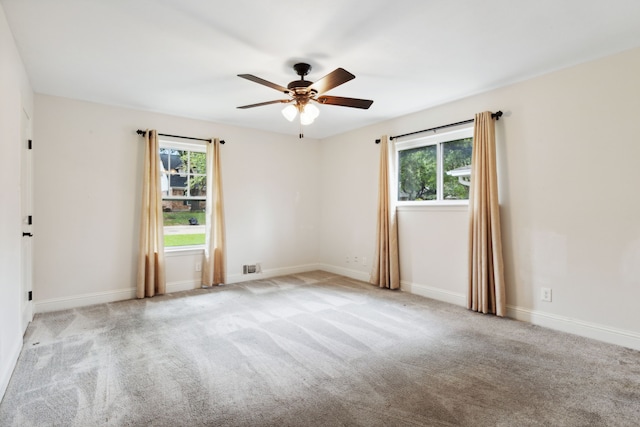 carpeted empty room featuring ceiling fan