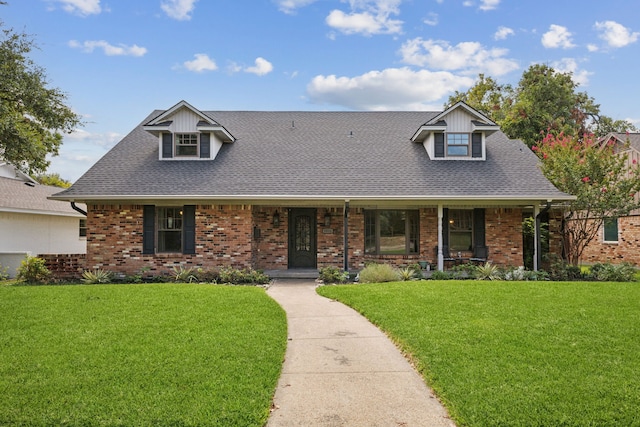 new england style home with a porch and a front yard