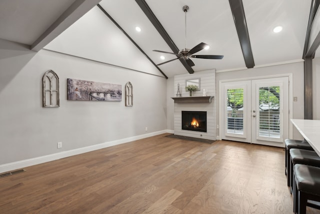 unfurnished living room featuring french doors, vaulted ceiling with beams, light hardwood / wood-style floors, and ceiling fan