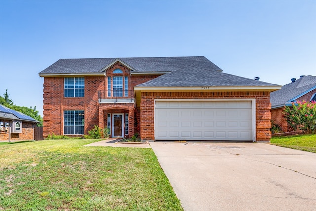 view of front facade featuring a garage and a front lawn