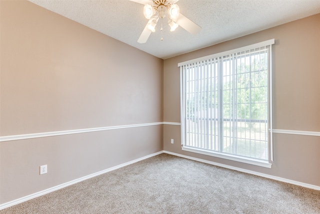 spare room with carpet floors, a textured ceiling, and ceiling fan