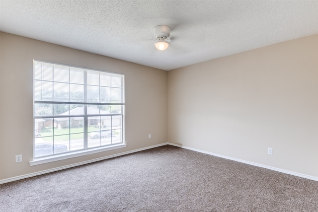 unfurnished room with ceiling fan, carpet, and a healthy amount of sunlight