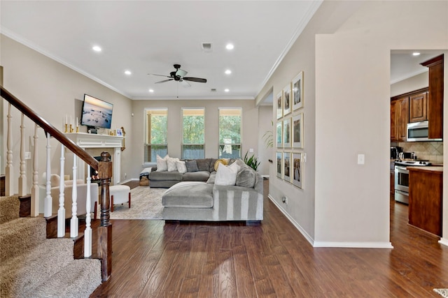 living room with ceiling fan, ornamental molding, and dark hardwood / wood-style floors