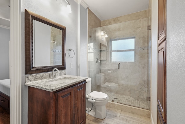 bathroom with vanity, an enclosed shower, wood-type flooring, crown molding, and toilet