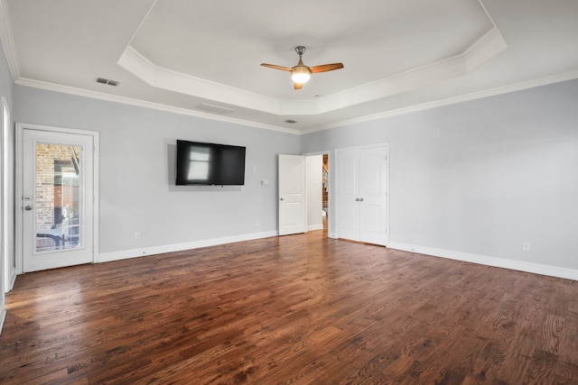 interior space featuring ceiling fan, a raised ceiling, dark hardwood / wood-style floors, and crown molding