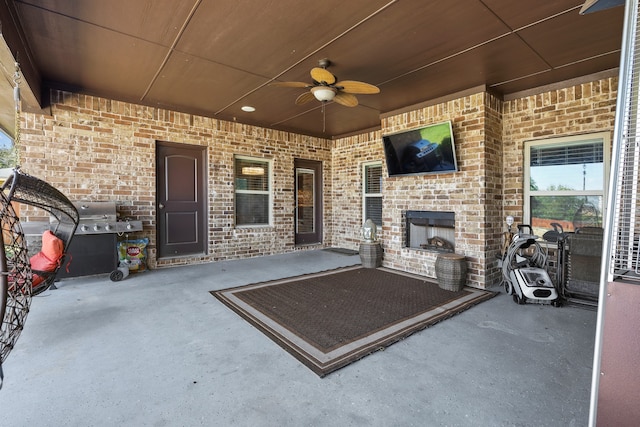 view of patio with ceiling fan and area for grilling