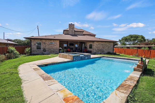 view of swimming pool with pool water feature, a yard, an in ground hot tub, and a patio area