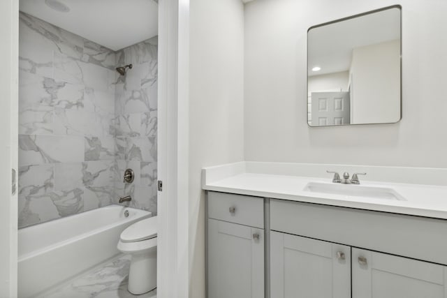 full bathroom featuring vanity, tiled shower / bath combo, and toilet