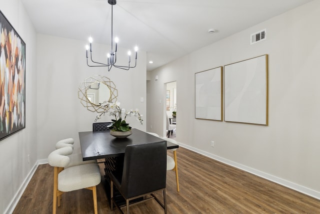 dining area with an inviting chandelier and dark hardwood / wood-style flooring