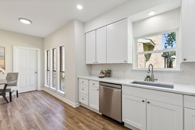 kitchen featuring white cabinets, dishwasher, plenty of natural light, and sink