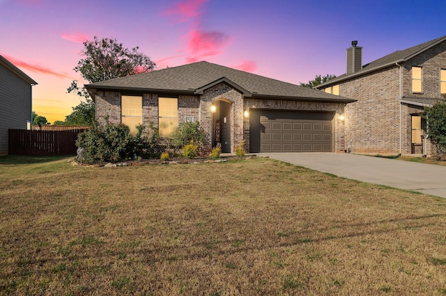 view of front of home featuring a garage and a yard