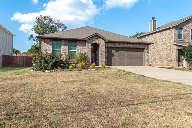 view of front facade featuring a front yard and a garage