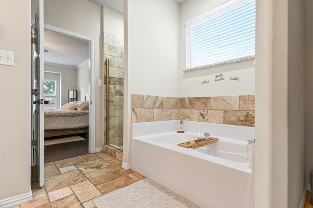 bathroom with ornamental molding and plus walk in shower