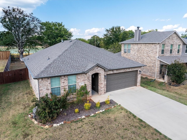 view of front of home featuring a garage and a front lawn