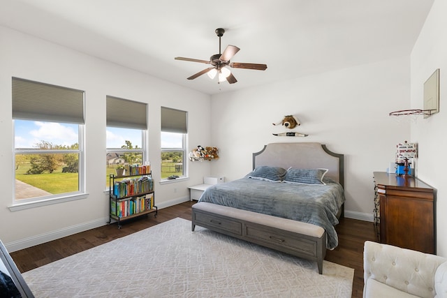 bedroom with multiple windows, hardwood / wood-style floors, and ceiling fan