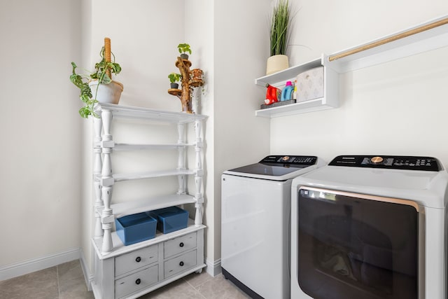 laundry area featuring light tile patterned floors and washer and clothes dryer