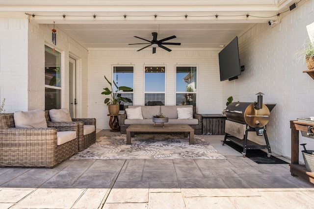 view of patio with area for grilling, outdoor lounge area, and ceiling fan