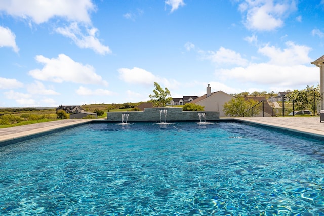 view of swimming pool featuring pool water feature