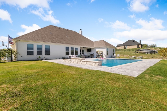 view of swimming pool with a patio and a yard