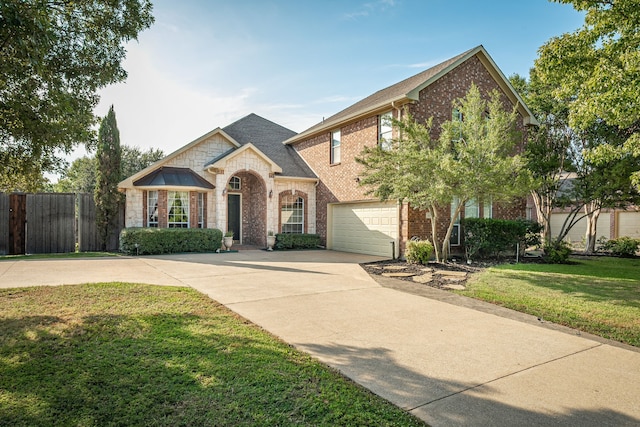 view of front of home featuring a front yard and a garage