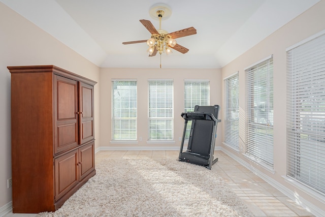 workout room with ceiling fan and light tile patterned floors