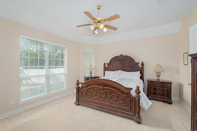 bedroom with light tile patterned floors, multiple windows, and ceiling fan