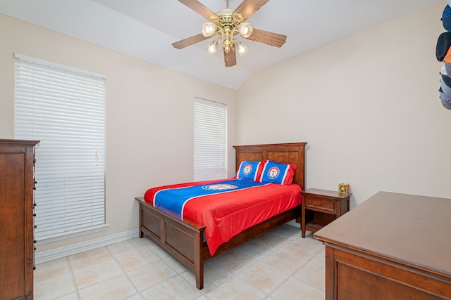 bedroom with light tile patterned floors, vaulted ceiling, and ceiling fan