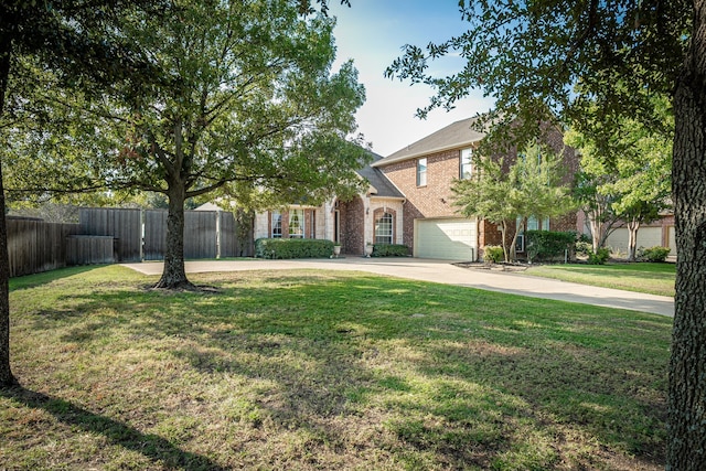 view of property hidden behind natural elements with a front lawn and a garage