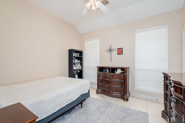 tiled bedroom with ceiling fan and lofted ceiling